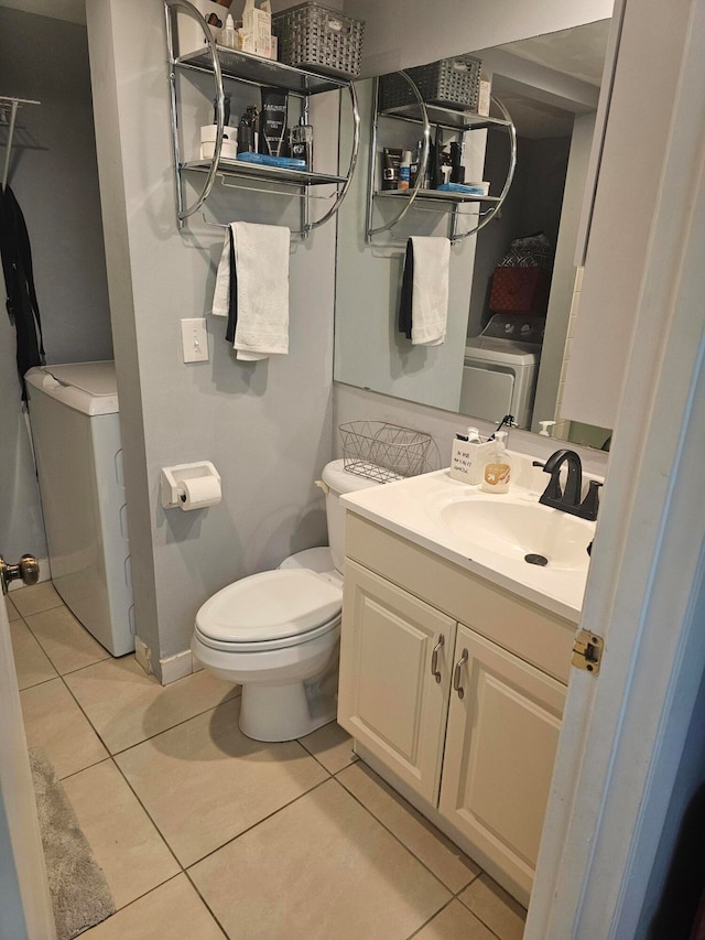 bathroom featuring tile patterned floors, vanity, and toilet