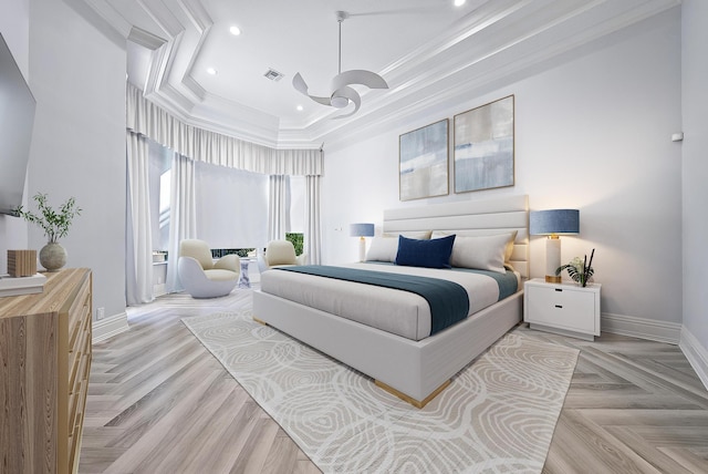 bedroom with ornamental molding, light parquet floors, and a raised ceiling