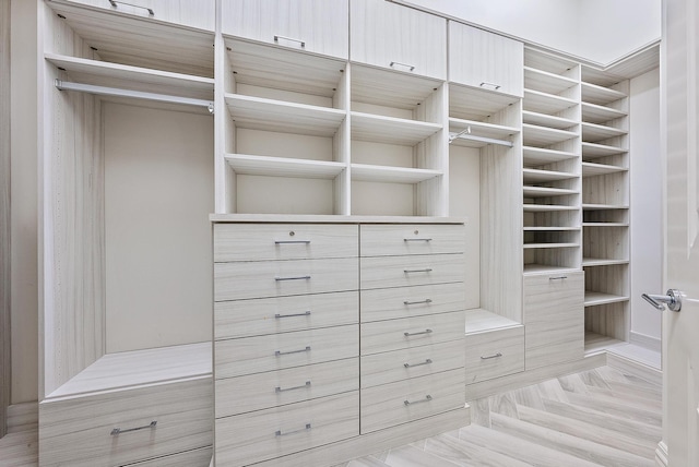 spacious closet featuring light parquet flooring