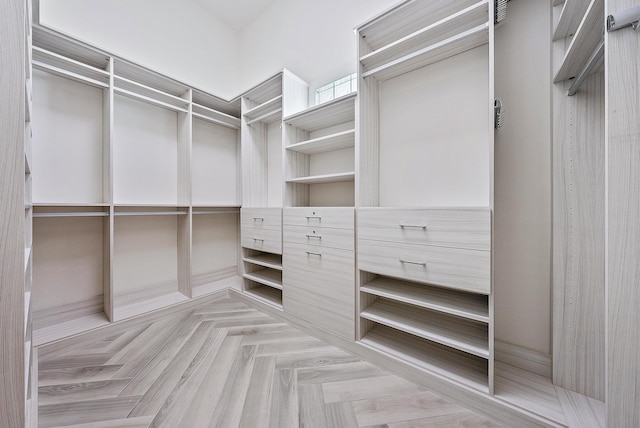 spacious closet with light parquet floors