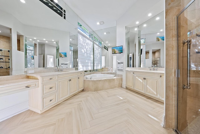 bathroom with parquet floors, shower with separate bathtub, and vanity