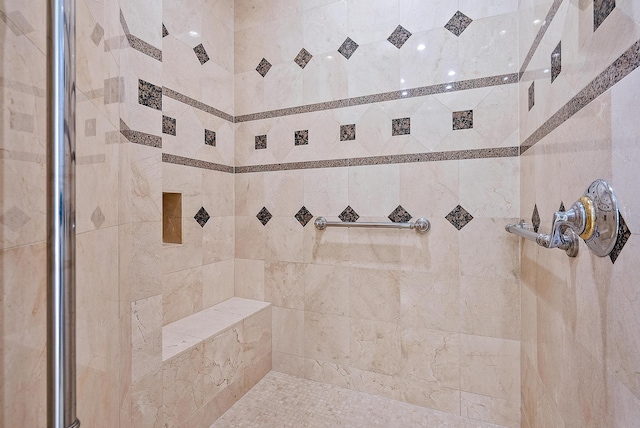 bathroom with a tile shower