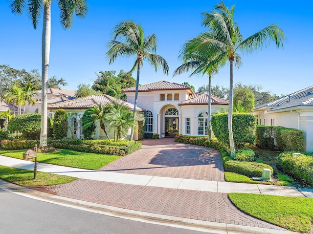 mediterranean / spanish-style house featuring a front yard