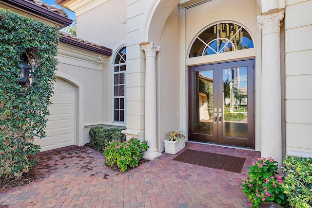 property entrance with a garage and french doors