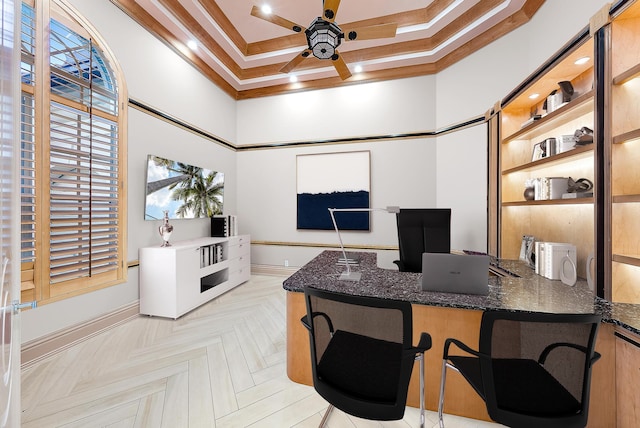 office area featuring ceiling fan, ornamental molding, a high ceiling, and built in desk