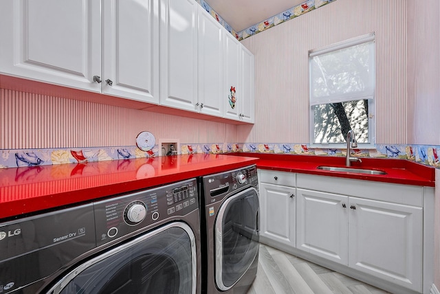 laundry room with washer and clothes dryer, sink, and cabinets