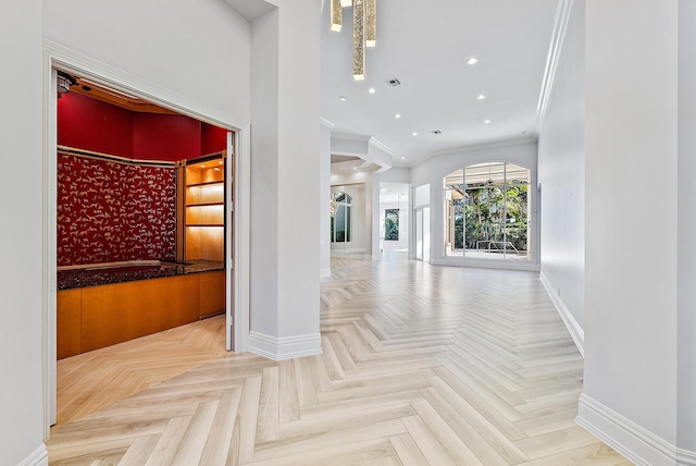 interior space with crown molding and light parquet flooring