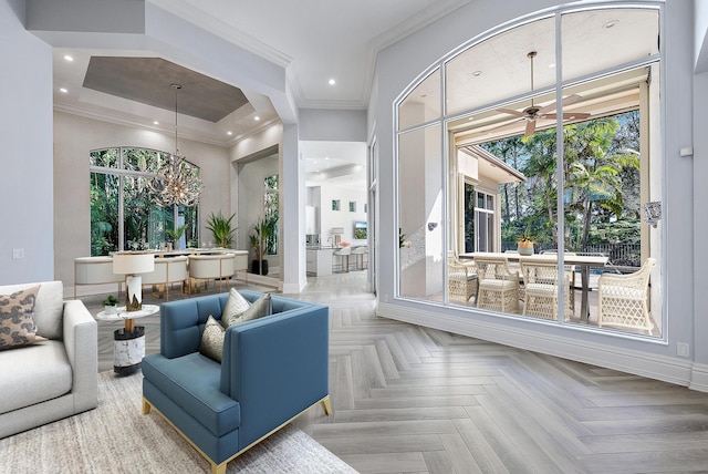 living room with ceiling fan, crown molding, and light parquet floors