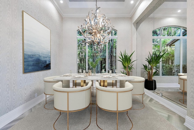 dining area featuring a raised ceiling, crown molding, and an inviting chandelier