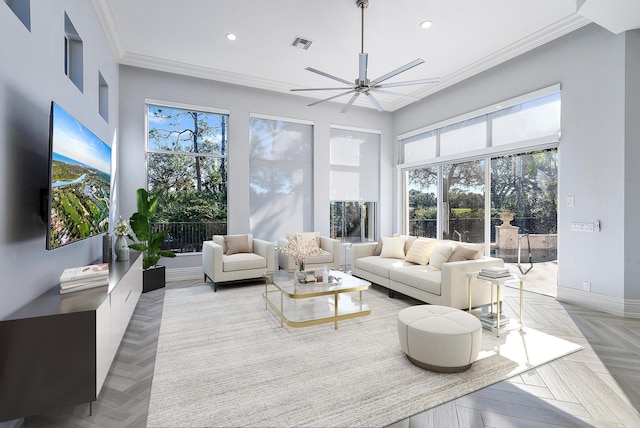 living room featuring ceiling fan, crown molding, and light parquet floors