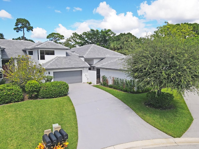 view of front of house with a garage and a front lawn