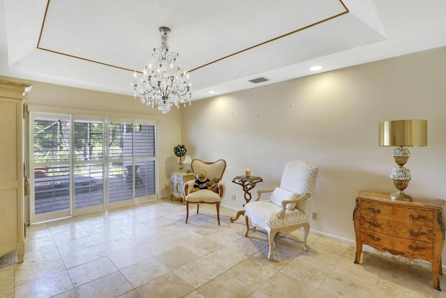 living area with a tray ceiling, a chandelier, and light tile patterned floors