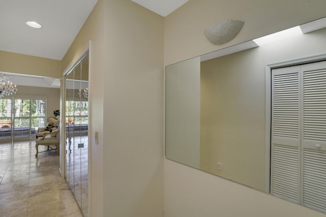 hallway featuring a notable chandelier