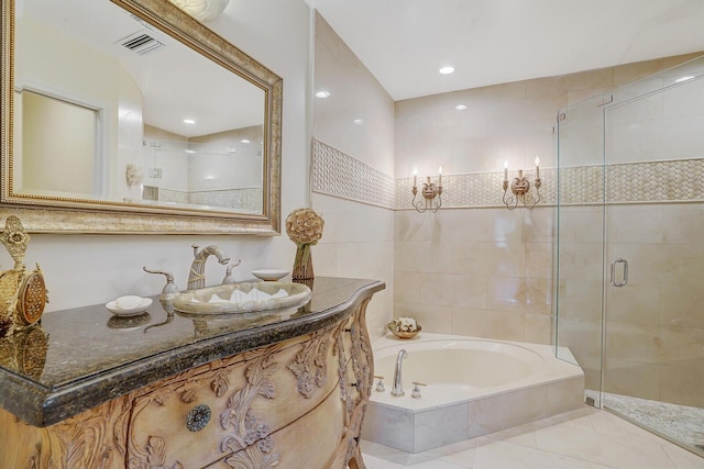 bathroom with tile patterned floors, shower with separate bathtub, and vanity