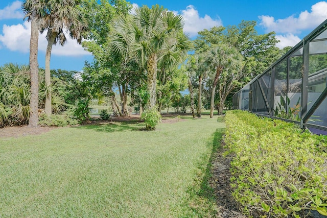 view of yard featuring glass enclosure