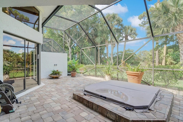 view of patio featuring glass enclosure