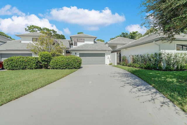 front facade featuring a garage and a front yard