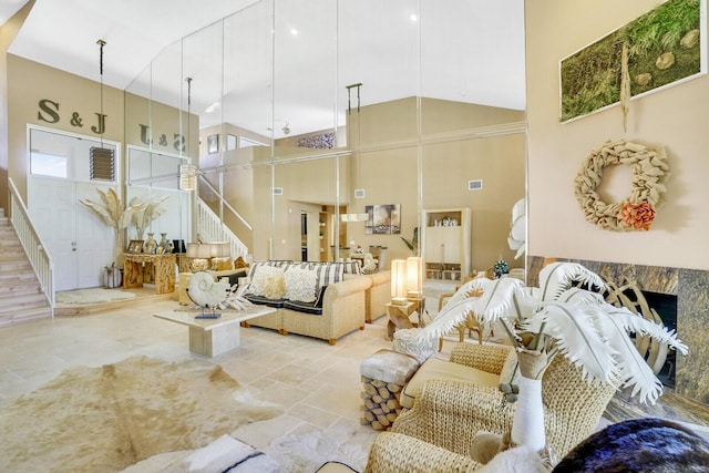 living room with plenty of natural light and high vaulted ceiling