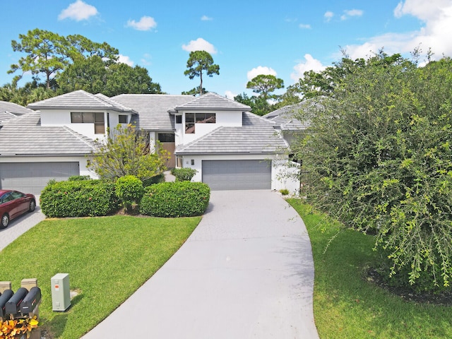 view of front facade with a garage and a front yard