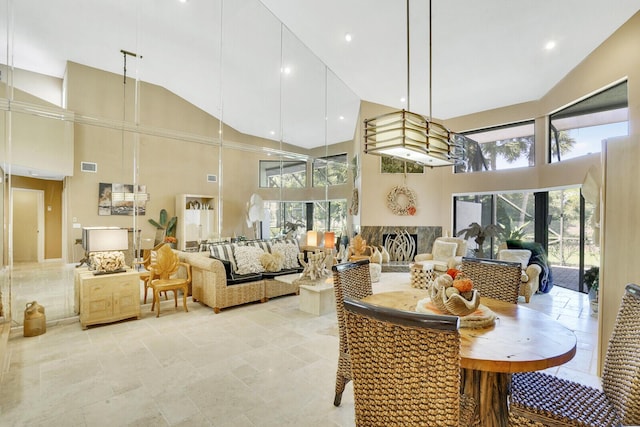 dining area with a towering ceiling