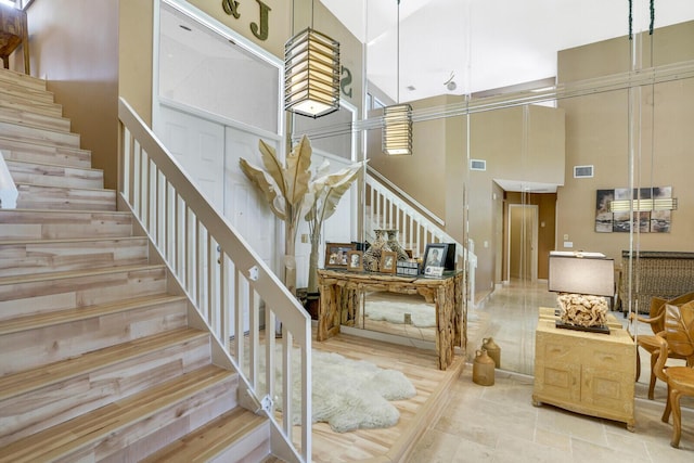 staircase featuring a high ceiling