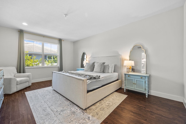 bedroom with dark hardwood / wood-style floors