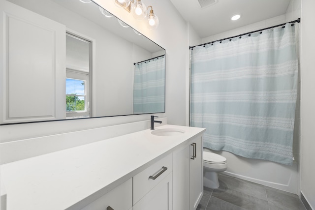 bathroom with tile patterned floors, vanity, and toilet