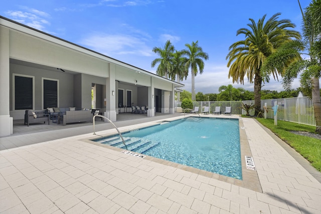 view of pool with outdoor lounge area and a patio