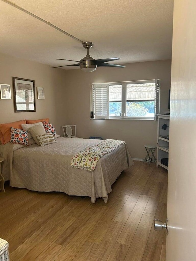 bedroom featuring wood-type flooring and ceiling fan