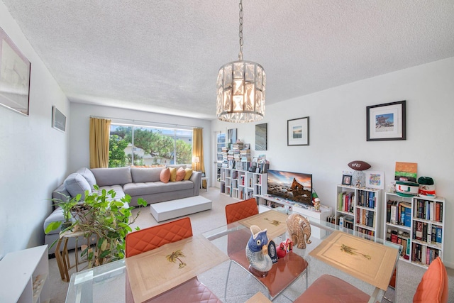 dining room featuring a textured ceiling, an inviting chandelier, and light colored carpet