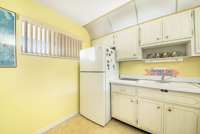 kitchen featuring white refrigerator and sink