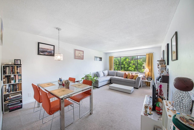 2581 N Garden Dr Unit 306, Lake Worth, FL 33461 - carpeted dining space with a textured ceiling and a chandelier