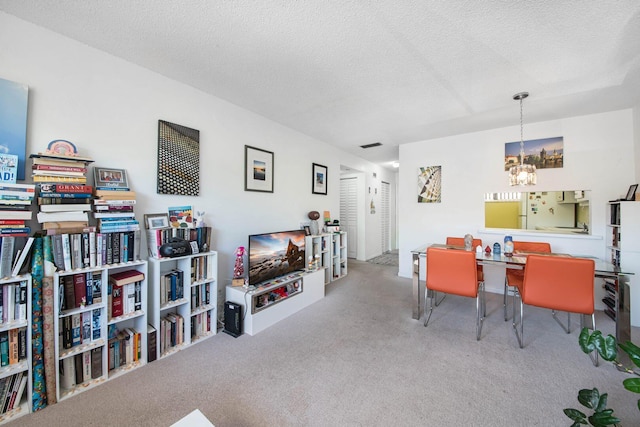 2581 N Garden Dr Unit 306, Lake Worth, FL 33461 - dining space featuring a chandelier, carpet, and a textured ceiling