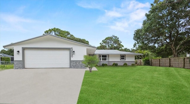 ranch-style home with a front yard and a garage