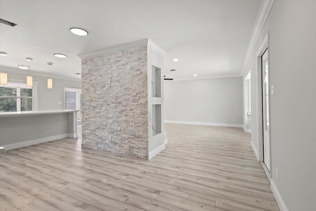 unfurnished living room featuring light hardwood / wood-style floors and crown molding