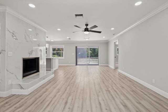 unfurnished living room with a fireplace, ceiling fan, light hardwood / wood-style flooring, and ornamental molding