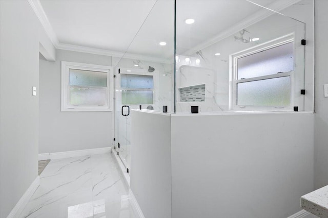 bathroom featuring a shower with door and crown molding