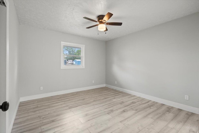 unfurnished room with ceiling fan, light hardwood / wood-style flooring, and a textured ceiling