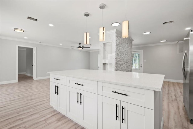 kitchen with light wood-type flooring, ceiling fan, decorative light fixtures, white cabinetry, and stainless steel refrigerator