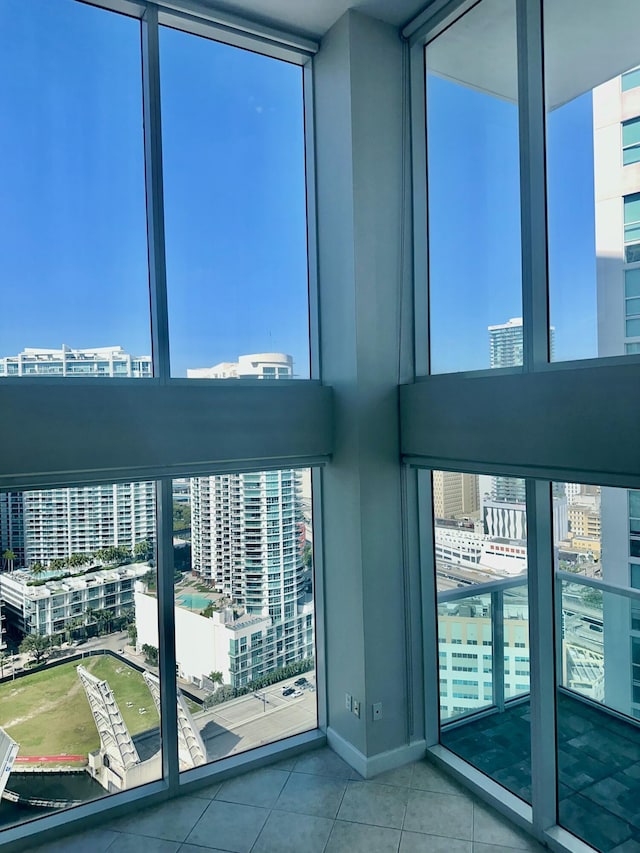 41 SE 5th St Unit 2017, Miami, FL 33131 - interior space featuring a city view, plenty of natural light, tile patterned flooring, and baseboards