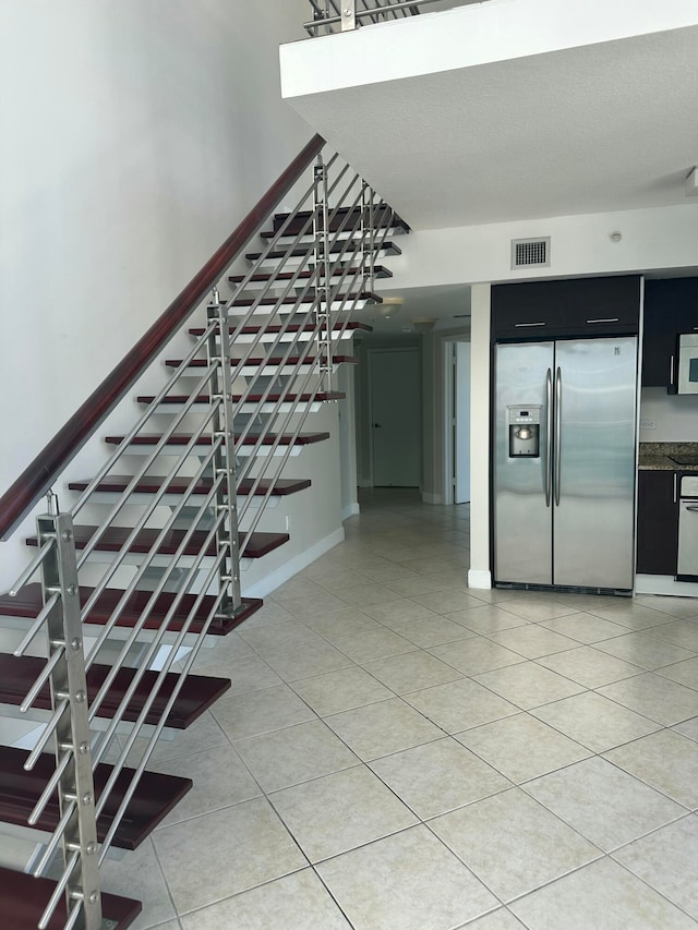 stairs with tile patterned flooring