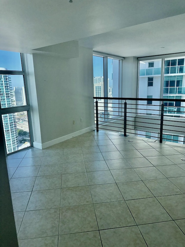 41 SE 5th St Unit 2017, Miami, FL 33131 - tiled empty room with healthy amount of natural light, baseboards, a city view, and floor to ceiling windows