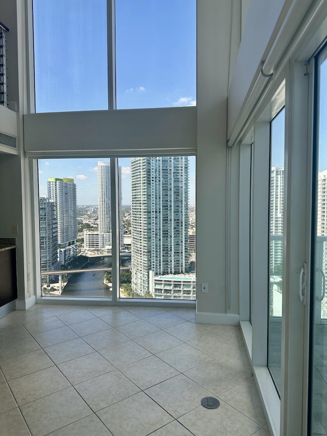 41 SE 5th St Unit 2017, Miami, FL 33131 - tiled spare room with a high ceiling, a city view, and baseboards