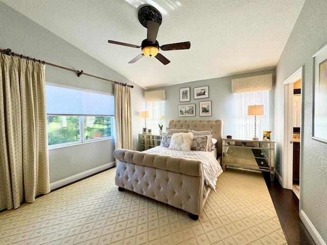 bedroom featuring a textured ceiling, light hardwood / wood-style flooring, ceiling fan, and lofted ceiling