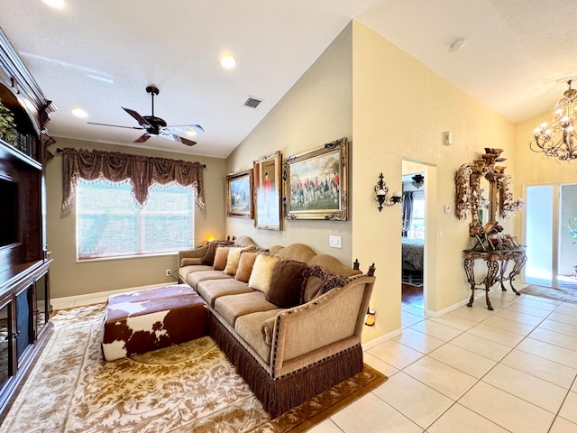 tiled living room with ceiling fan with notable chandelier and vaulted ceiling