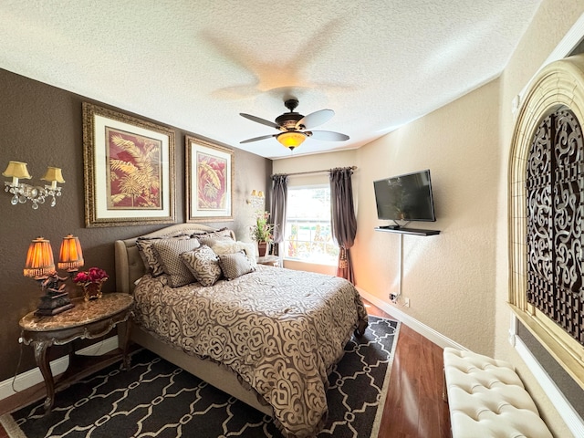 bedroom with radiator, a textured ceiling, ceiling fan, and hardwood / wood-style floors