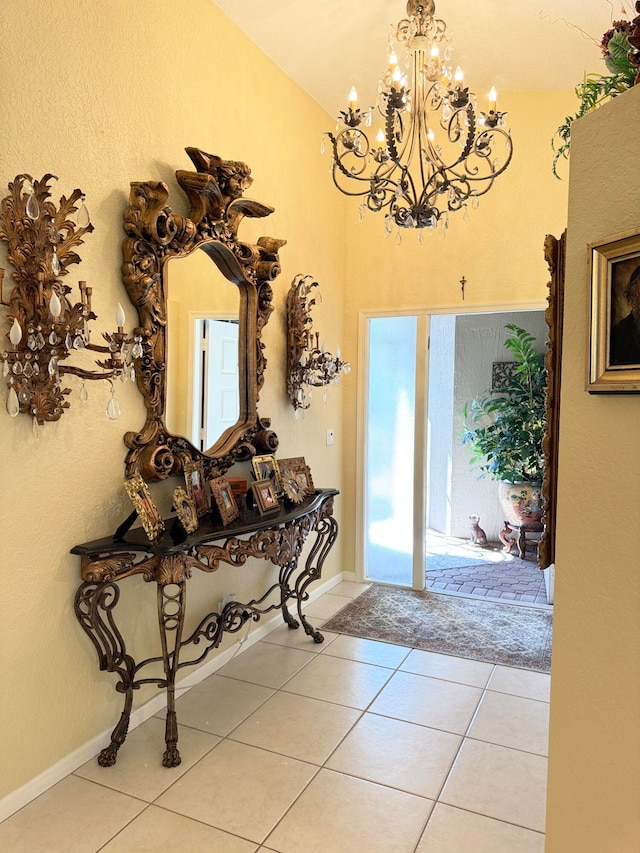 tiled foyer featuring a chandelier