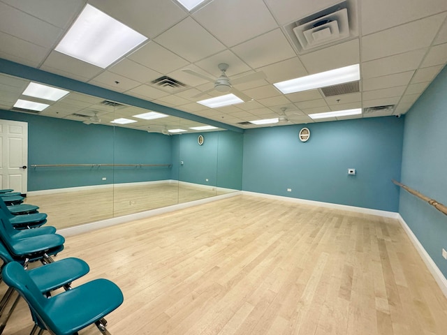 spare room with a drop ceiling and wood-type flooring