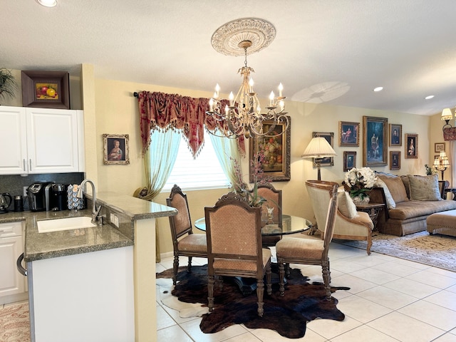 dining area featuring a notable chandelier, light tile patterned floors, and sink