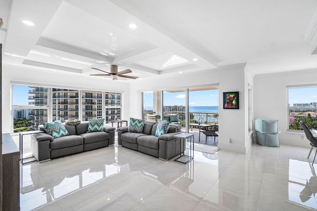 living room with a water view, ornamental molding, ceiling fan, and a wealth of natural light